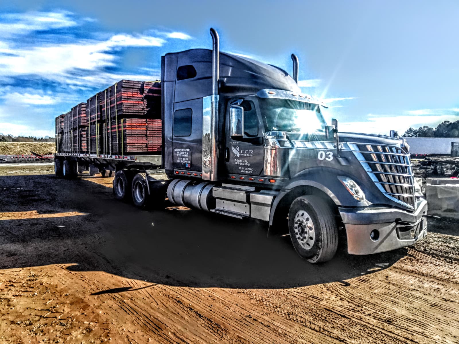 SSR Logistics International Lonestar hauling a loaded flatbed